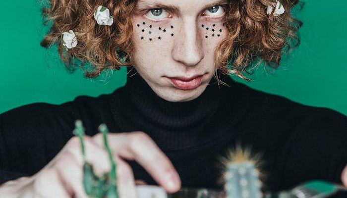 Person smiling and looking refreshed outdoors in a park.